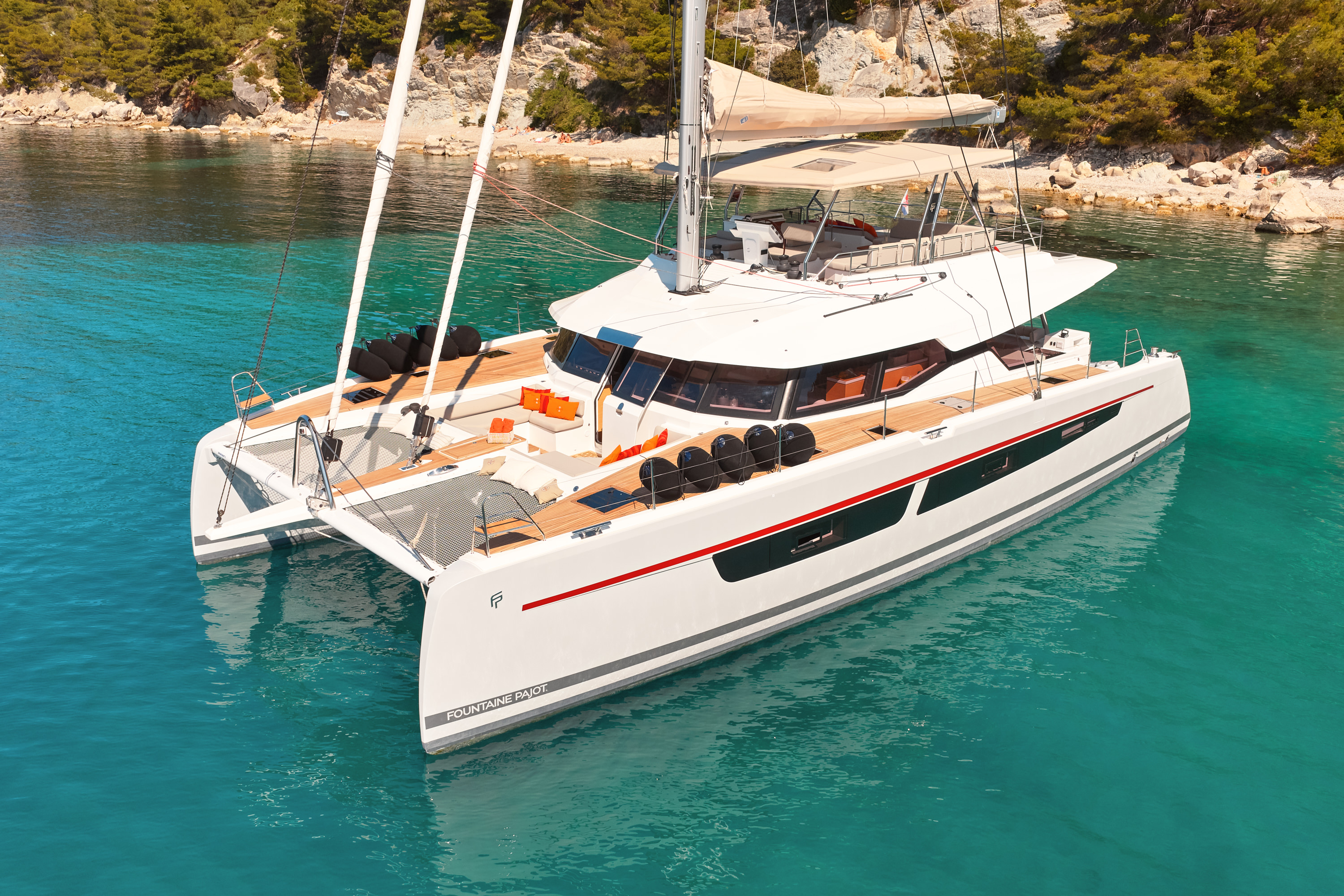 Aerial view of NIKA I stern at anchor in turquoise cove, guests and tender alongside, Croatian bay