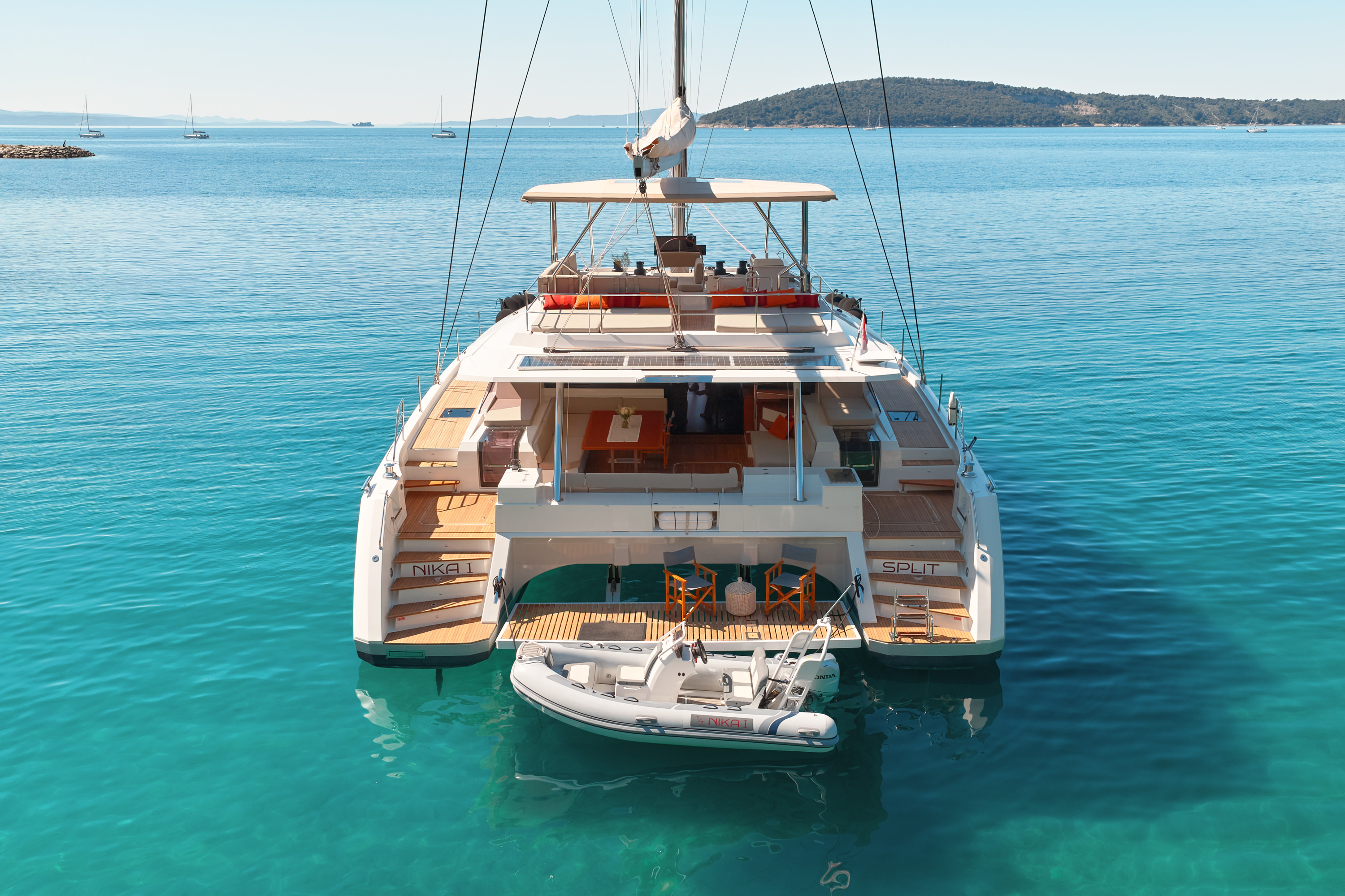 Aerial top-down, symmetric hull view, turquoise water surrounding, excellent for showing yacht scale