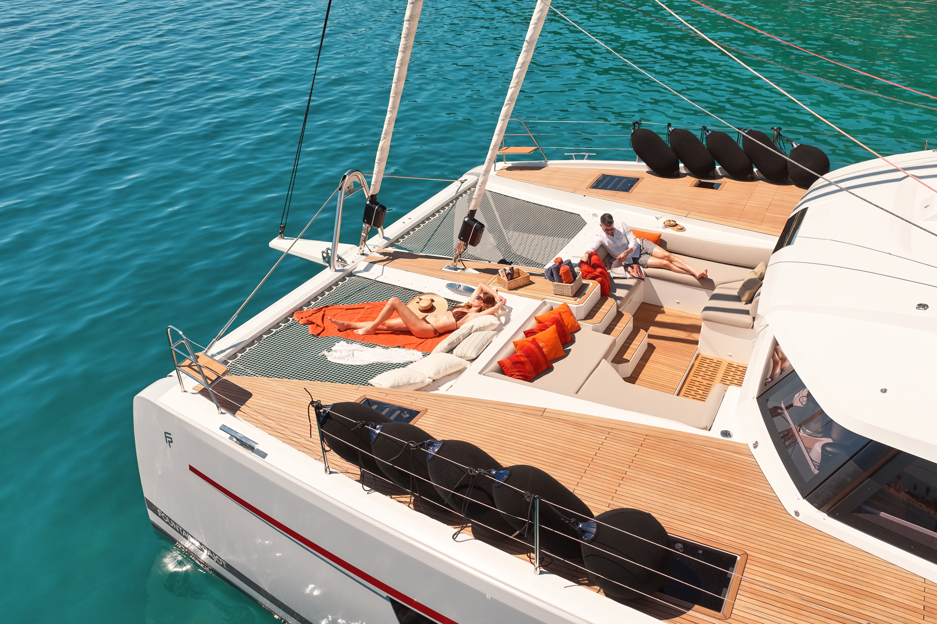 Aerial under sail, good angle showing Samana 59 twin-hull silhouette against blue water