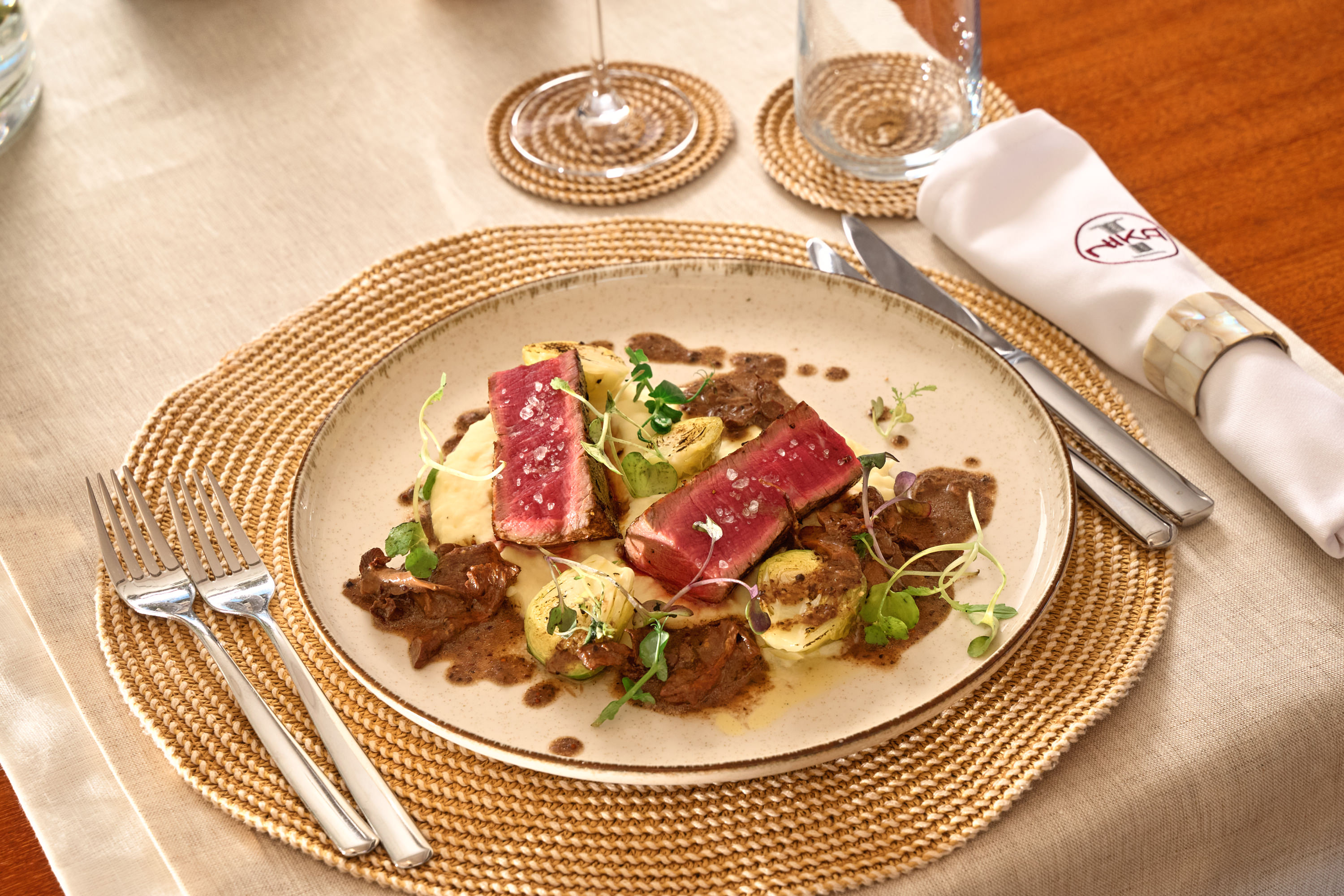 Seared tuna with truffle mushrooms and potato, microgreens, artisan plating, NIKA branded napkin