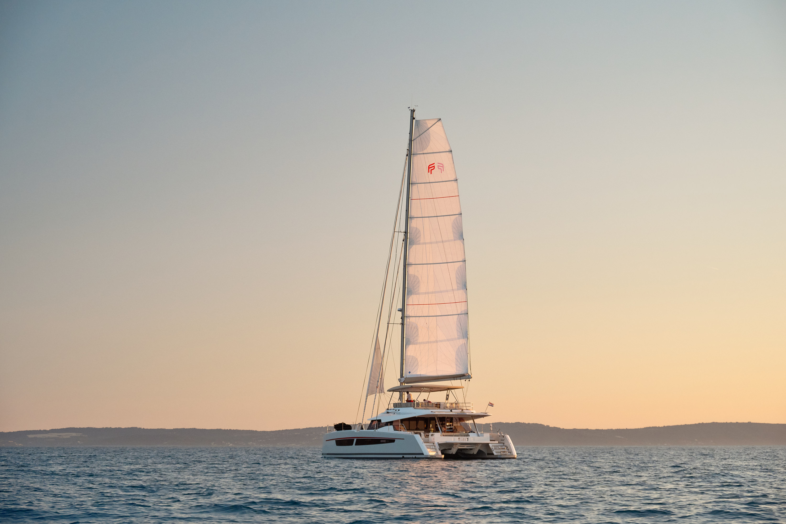 NIKA I luxury catamaran sailing at sunset, Adriatic coast Croatia